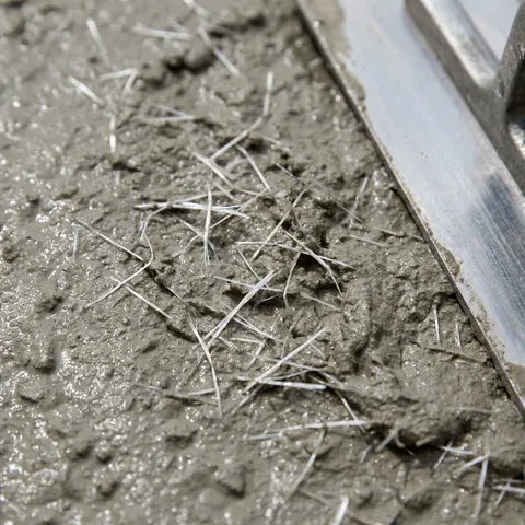 Freshly placed 3000 PSI Fiber-Reinforced concrete surface being finished